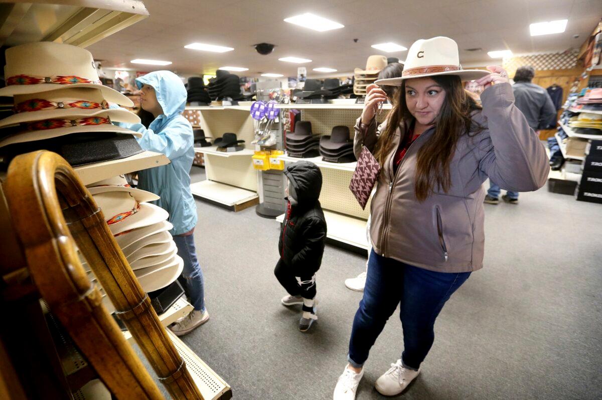 Irene Schaefer of Johnson Creek, Wis., shops for hats at Longhorn Saddlery in Dubuque, Iowa, on Dec. 30, 2022. (Jessica Reilly/Telegraph Herald via AP)