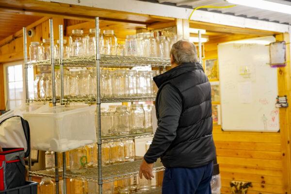 A customer returns reusable milk bottles at Freedom Hill Farm in Otisville, N.Y., on Jan. 13, 2023. (Cara Ding/The Epoch Times)