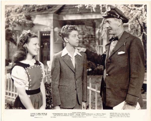 (L–R) Pat (Joan Carroll) introduces Emil (Skip Homeier) to townsperson (Tom Fadden), in "Tomorrow, the World!" (United Artists)