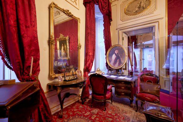 This room offers a deeper insight into the life of  Emperor Franz Joseph. He used this room as a study and drawing room. Behind the desk is the famous portrait of Empress Elizabeth by Franz Xaver Winterhalter. (Marcobrivio.photo/Shutterstock)