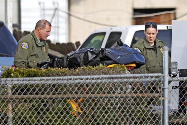 Tulare County Sheriff crime unit removes the body of one of the victims at the scene of a shooting, in Goshen, Calif., on Jan. 16, 2023. (Gary Coronado/Los Angeles Times via AP)