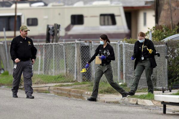 Tulare County Sheriff crime unit investigates the scene of a shooting, in Goshen, Calif., on Jan. 16, 2023. (Gary Coronado/Los Angeles Times via AP)