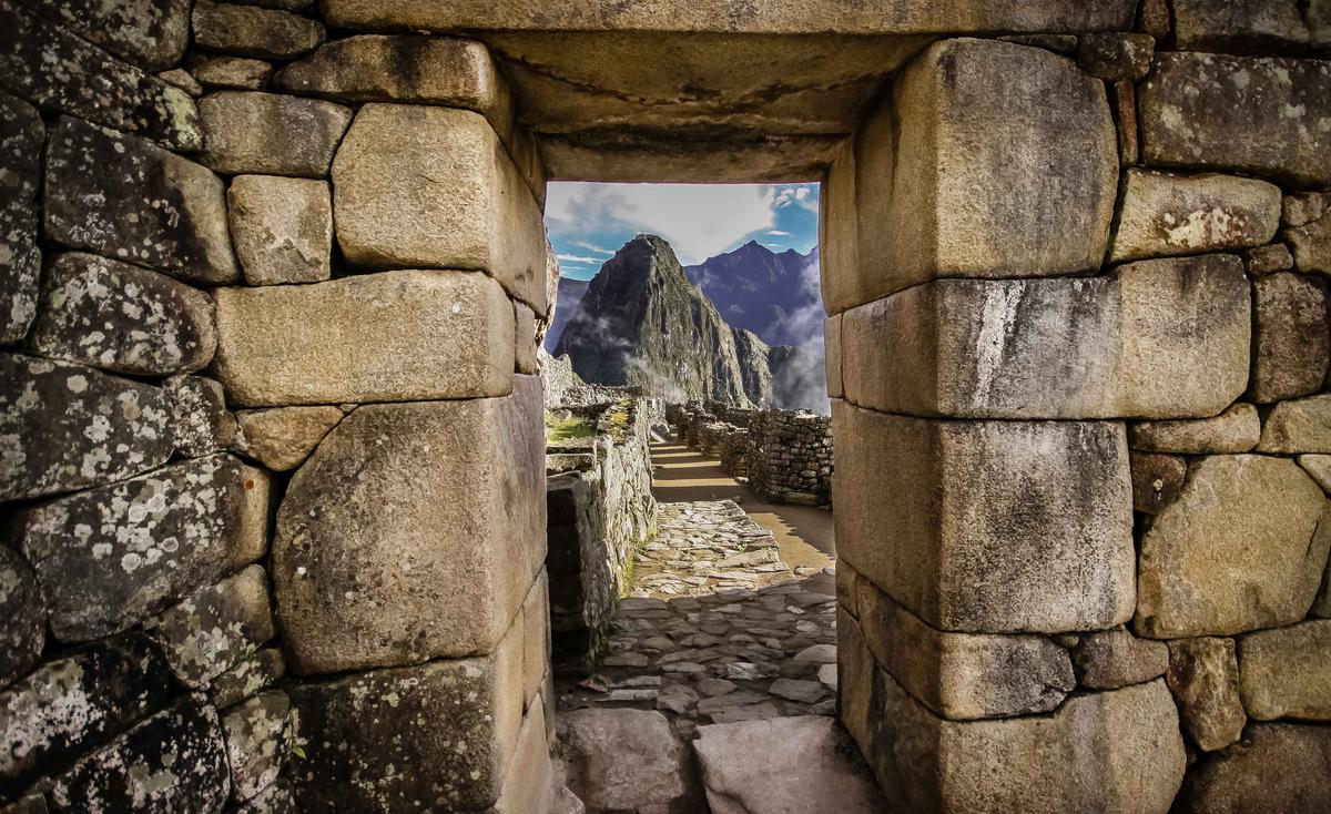 A stone doorway at Machu Picchu frames a view of neighboring peak Huayna Picchu. (Uwe Bergwitz/Shutterstock)