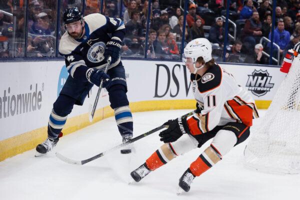Columbus Blue Jackets' Erik Gudbranson, left, clears the puck past Anaheim Ducks' Trevor Zegras during the first period of an NHL hockey game in Columbus, Ohio, on Jan. 19, 2023. (Jay LaPrete/AP Photo)