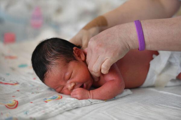 A nurse cares for a newborn at the Women and Children's Hospital in Fuyang City, Anhui Province, China, on Aug. 8, 2022. (Cfoto/Future Publishing via Getty Images)