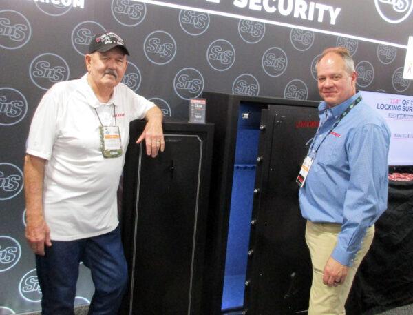 (Right) Ken Stacy, (North American representative for Lokaway safes) and (Left) Corkey Whempner (Lokaway sales representative) display one of their company's gun safes during the National Shooting Sports Foundation's 45th annual SHOT Show in Las Vegas, Nev., on Jan. 18, 2023. (Michael Clements)