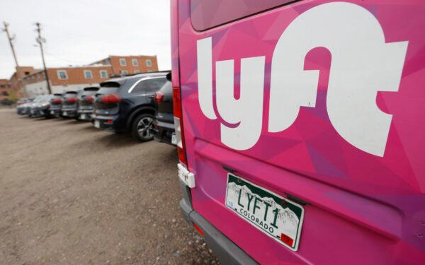 A Lyft ride-hailing vehicle sits unused in a lot near Empower Field at Mile High in Denver on April 30, 2020. (David Zalubowski/AP Photo)