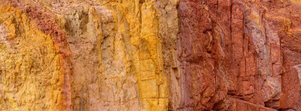 A rock face full of iron oxides shows a rainbow of red, brown, and yellow earth pigments that artists can use to make paints such as yellow ocher. (Courtesy of Natural Pigments)