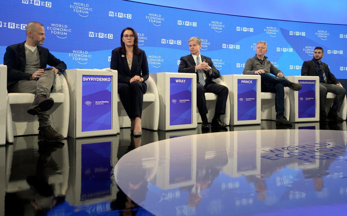 From left, editor of Wired Magazine Gideon Lichfield, Ukraine Vice-Prime Minister Yulia Svyrydenko, FBI Director Christopher Wray, CEO Cloudflare Matthew Prince, and CEO of Gecko Robotics Jake Loosararian, sit on a podium at the World Economic Forum in Davos, Switzerland, on Jan. 19, 2023. (AP Photo/Markus Schreiber)