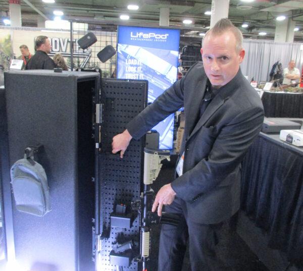 Dustin Culbreth, vice president for product development of Vaultek, demonstrates the features of one of his company's long gun safes during the National Shooting Sports Foundation's 45th annual SHOT Show in Las Vegas on Jan. 18, 2023.  (Michael Clements/The Epoch Times)