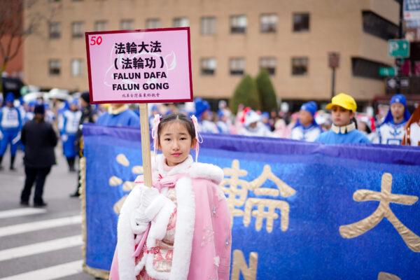 Falun Gong practitioners take part in the Chinese New Year Parade in Flushing, New York, on Jan. 21, 2023 (Samira Bouaou/The Epoch Times)