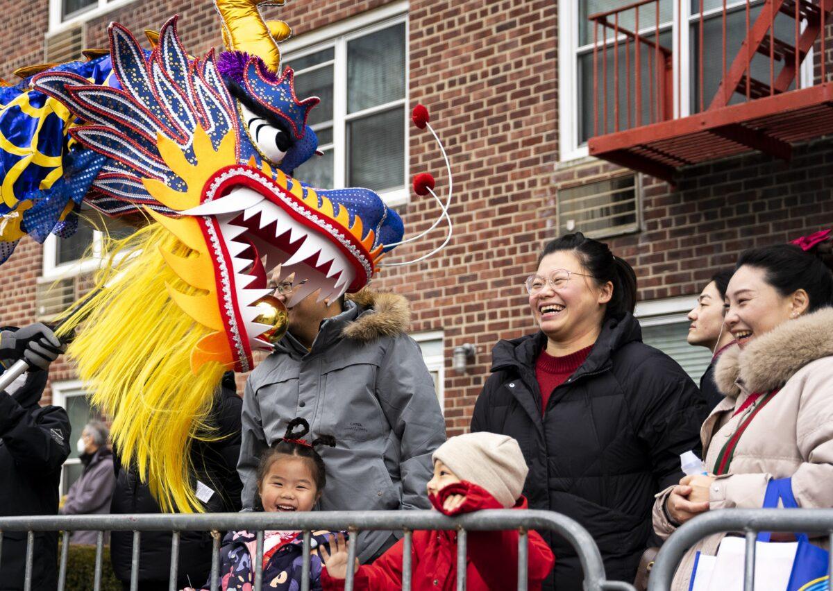  Bystanders interact with Falun Gong practitioners during the Chinese New Year parade in Flushing, N.Y., on Jan. 21, 2023. (Chung I Ho/The Epoch Times)