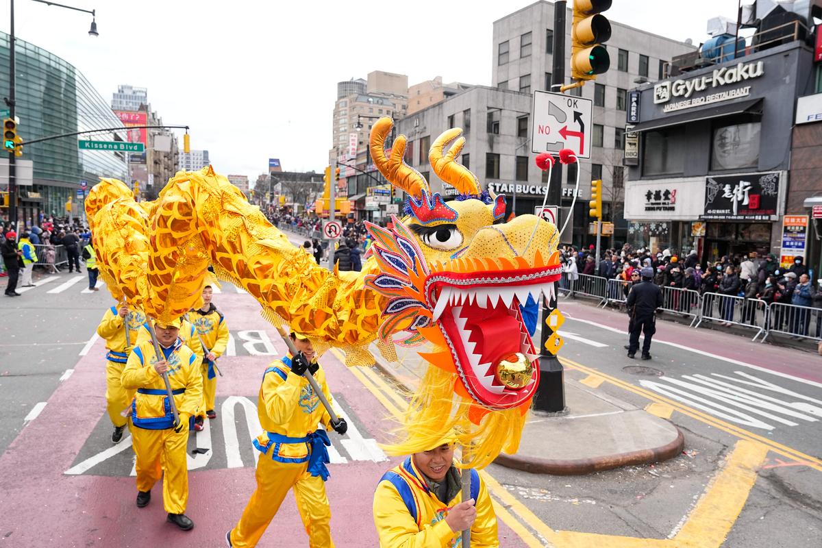 Falun Gong practitioners take part in the Chinese New Year Parade in Flushing, N.Y., on Jan. 21, 2023. (Larry Dye/The Epoch Times)