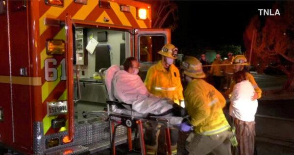 Screenshot from a video shows emergency responders assisting a person to an ambulance following a shooting at Monterey Park, Calif., on Jan. 22, 2023. (TNLA/Handout via Reuters)