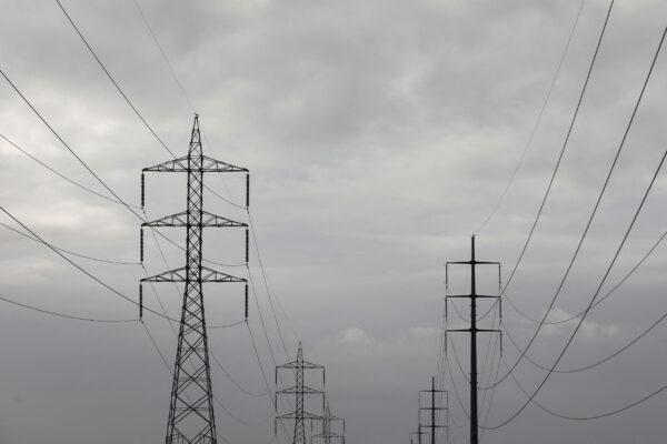 Power transmission towers are pictured in Karachi, Pakistan, on July 26, 2022. (Akhtar Soomro/Reuters)
