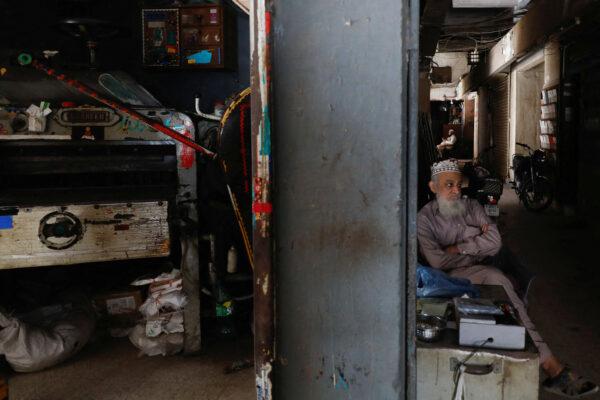 A man sits outside his shop during a country-wide power breakdown in Karachi, Pakistan, on Jan. 23, 2023. (Akhtar Soomro/Reuters)