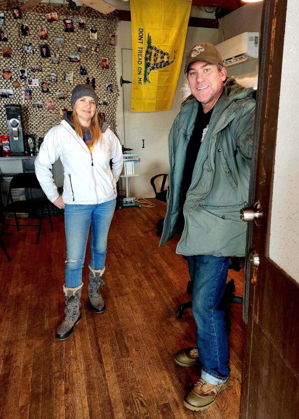 Tom West and his wife Shannon Francis stand in the doorway at Operation: Transition Outside the Wire, a nonprofit they started to help at-risk veterans, in Williams, Ariz., on Jan. 16, 2023. (Allan Stein/The Epoch Times)