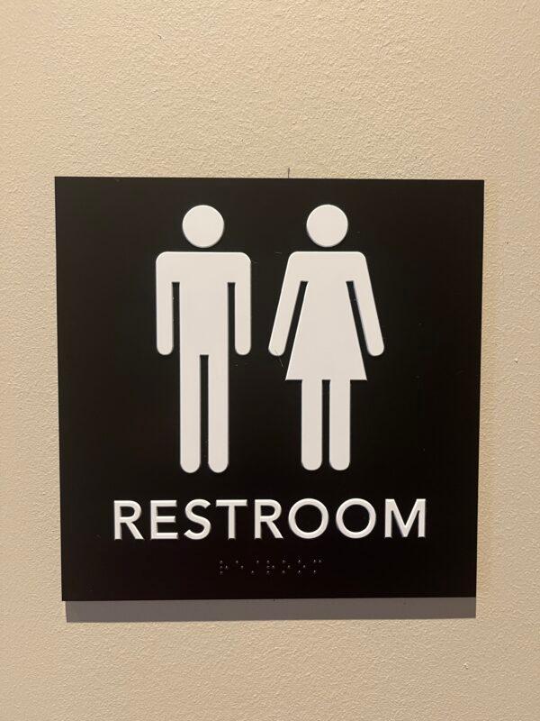 A sign on a single-person bathroom at a Starbucks in Gainesville, Fla., on Jan. 23, 2023 indicates it's offered for male and female users, instead of being designated by gender. (Nanette Holt/The Epoch Times)