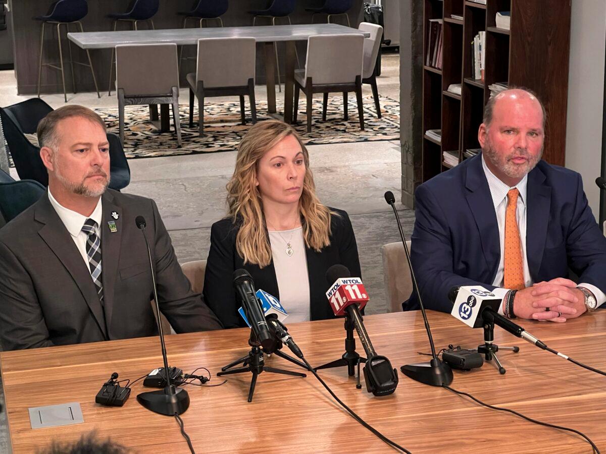 Cory Foltz (L) and his wife Shari Foltz sit next to attorney Rex Elliott in a press conference where Elliott announced that the Foltz family will receive nearly $3 million from Bowling Green State University to settle its lawsuit on Jan. 23, 2023. (Patrick Orsagos/AP Photo)