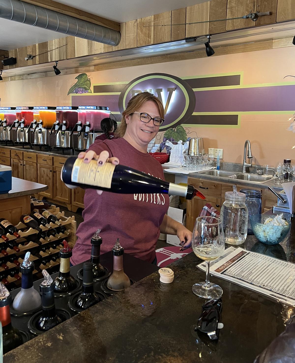 JoLee Kasprzak, one of the managers of Patoka Lake Winery in Birdseye, pours samples of wine for customers. The winery also includes overnight accommodations with winery suites and unique silo suites that are converted from silos. Wine cruises are offered at nearby Patoka Lake Marina. (Mary Ann Anderson/TNS)