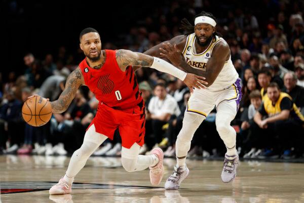 Damian Lillard (0) of the Portland Trail Blazers dribbles against Patrick Beverley (21) of the Los Angeles Lakers during the fourth quarter at Moda Center in Portland on Jan. 22, 2023. (Steph Chambers/Getty Images)