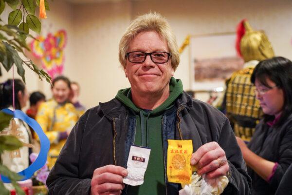 Jon Crawn holds tea bags he bought at the Chinese New Year celebration event at the Erie Trackside Manor in Port Jervis, N.Y., on Jan. 22, 2023. (Cara Ding/The Epoch Times)