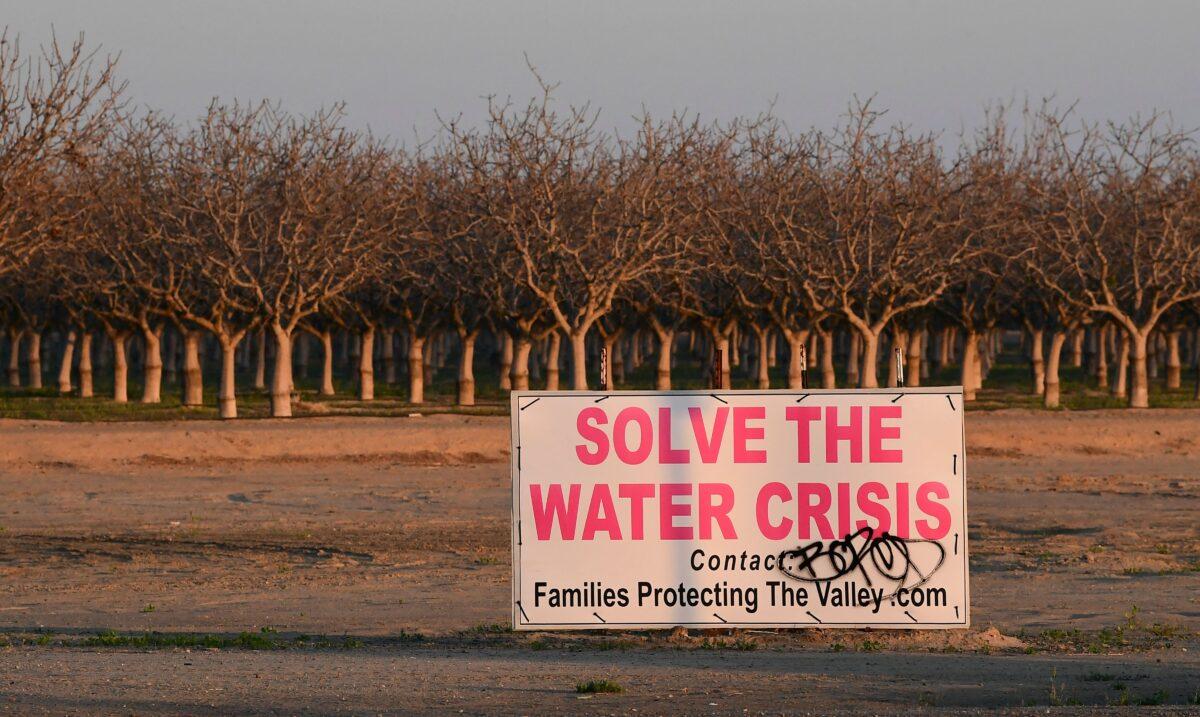 A sign calls for solving California's water crisis on the outskirts of Buttonwillow in California's Kern County on April 2, 2021. (Frederic J. Brown/AFP via Getty Images)