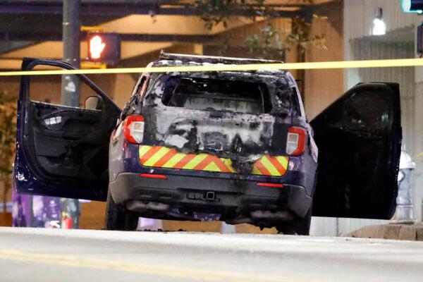 A burned police car sits on the street following a riot in Atlanta, Ga., on Jan. 21, 2023. (AP Photo/Alex Slitz)