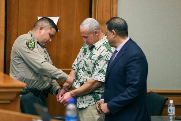 A court officer removes Albert "Ian" Schweitzer's handcuffs following the judge's decision to release him from prison immediately after his attorneys presented new evidence at a hearing in Hilo, Hawaii, on Jan. 24, 2023, and argued that he didn’t commit the crimes he was convicted of and spent more than 20 years locked up for: the 1991 murder, kidnapping and sexual assault of a woman visiting Hawaii. (Marco Garcia/The Innocence Project via AP Images)