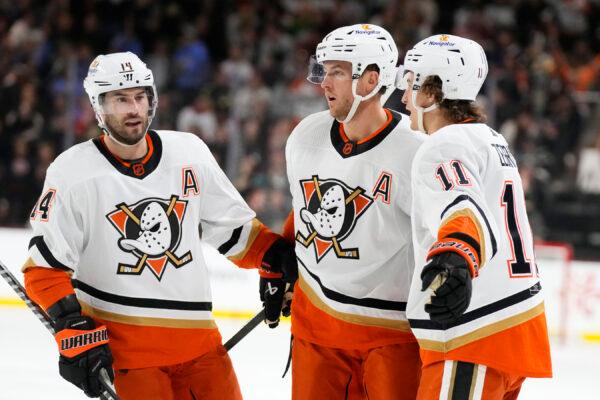 Anaheim Ducks defenseman Cam Fowler celebrates his goal against the Arizona Coyotes with centers Adam Henrique (14) and Trevor Zegras (11) during the second period of an NHL hockey game in Tempe, Ariz., on Jan. 24, 2023. (Ross D. Franklin/AP Photo)