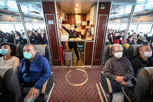 Hong Kong tourists riding a ferry heading from Hong Kong to the southern Chinese enclave of Macau on Jan. 17, 2023. (Peter Parks/AFP via Getty Images)