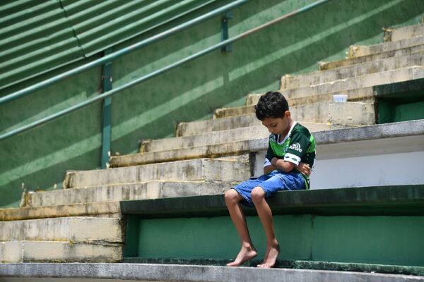 A boy sits alone on the stands at Arena Conda stadium in Chapeco, in the southern Brazilian state of Santa Catarina, on Nov. 29, 2016. (Nelson Almeida/AFP via Getty Images)