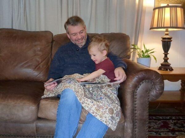 Paul Vaughn, 55, reads a story to his youngest child at their home in Hickman County, Tenn., in an undated photo. (Courtesy of Paul Vaughn)