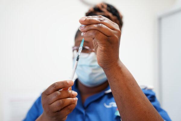A nurse prepares a dose of a COVID-19 vaccine in Coventry, England, on April 22, 2022. (Jacob King - WPA Pool/Getty Images)