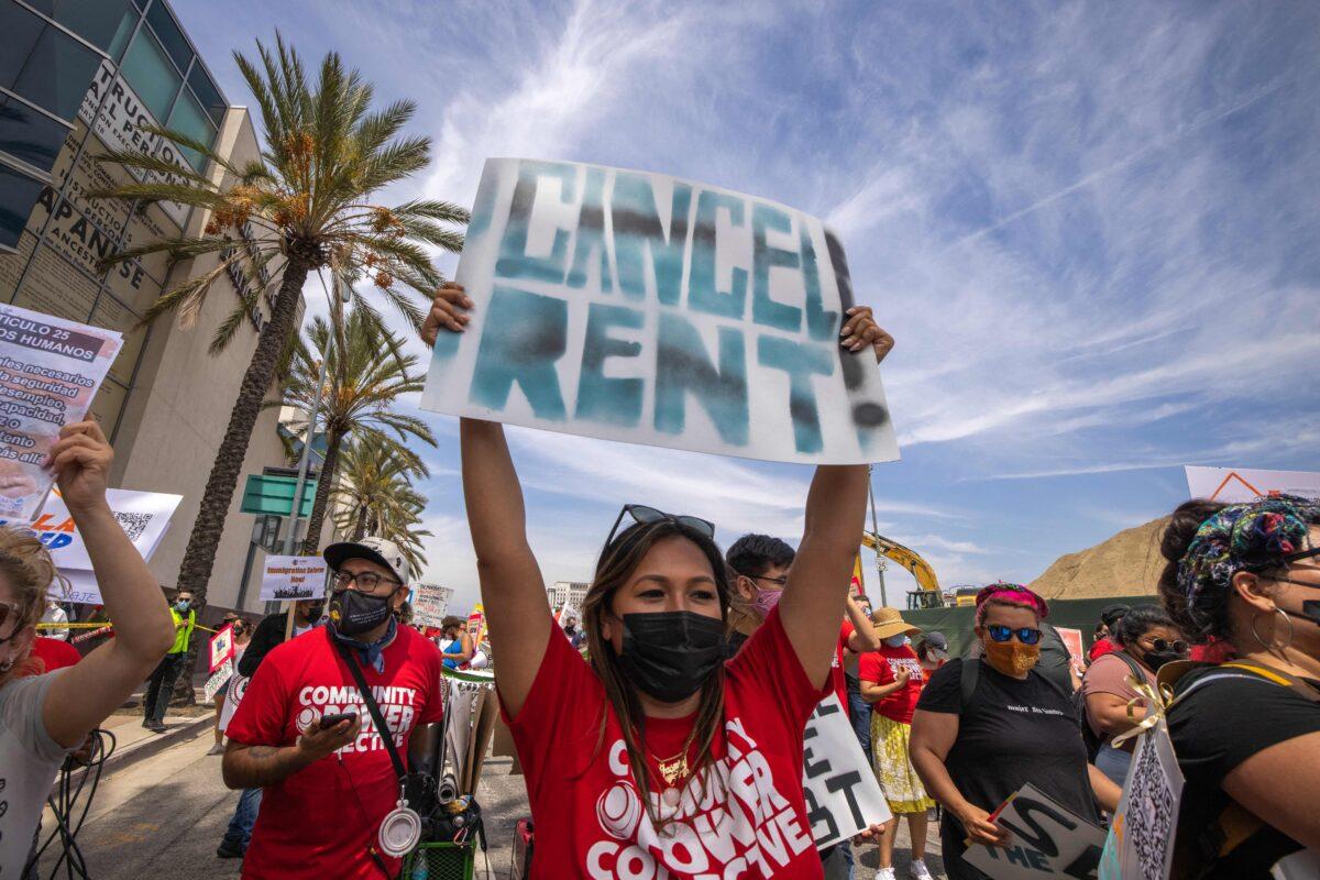 A woman calls for rent cancellation as a coalition of activist groups and labor unions participate in a May Day march for workers' and human rights in Los Angeles on May 1, 2021. (David McNew/AFP via Getty Images)