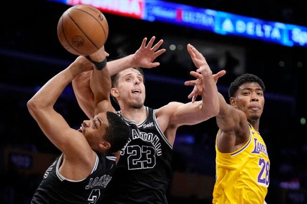 San Antonio Spurs forward Keldon Johnson, left, forward Zach Collins, center, and Los Angeles Lakers forward Rui Hachimura go after a rebound during the first half of an NBA basketball game in Los Angeles on Jan. 25, 2023. (Mark J. Terrill/AP Photo)