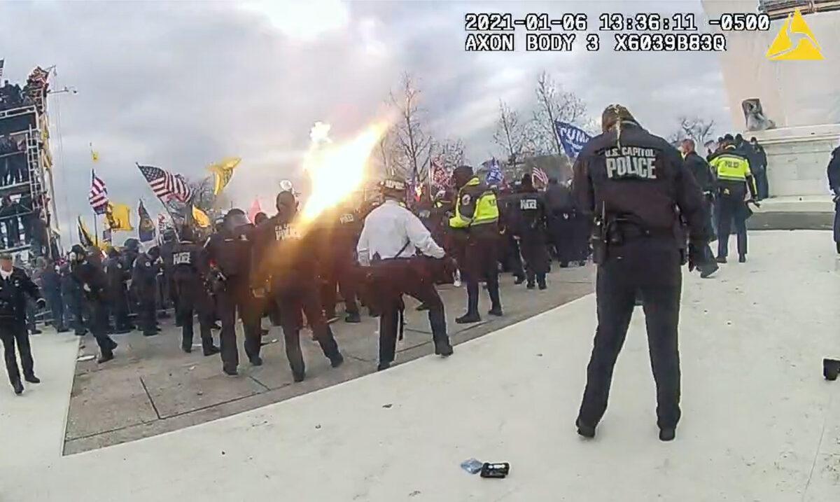 A grenade tossed by D.C. police officer Daniel Thau explodes over the heads of protesters at the U.S. Capitol at 1:36 p.m. on Jan. 6, 2021. (Metropolitan Police Department/Screenshot via The Epoch Times)