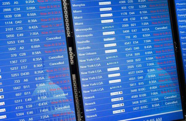 A flight information display lists canceled and delayed flights due to an FAA outage that grounded flights across the United States at Ronald Reagan Washington National Airport in Arlington, Va., on Jan. 11, 2023. (Saul Loeb/AFP via Getty Images)