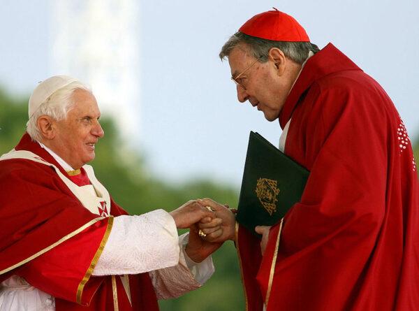 Pope Benedict XVI shakes hands with Cardinal George Pell during the Final Mass at Southern Cross Precinct during World Youth Day in Sydney, Australia, on July 20, 2008. (World Youth Day via Getty Images)