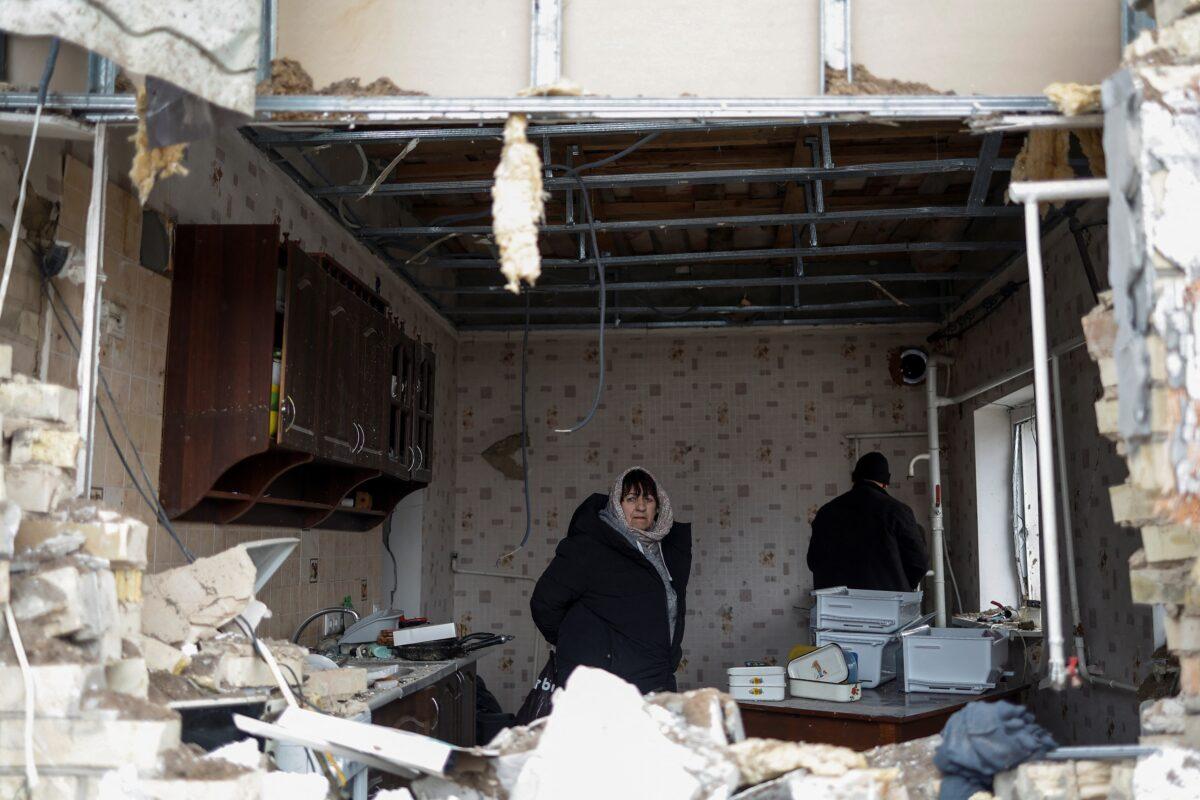 Local resident Halyna, 67, looks out from a kitchen of her house damaged by a Russian military strike in the town of Hlevakha, outside Kyiv, Ukraine, on Jan. 26, 2023. (Valentyn Ogirenko/Reuters)