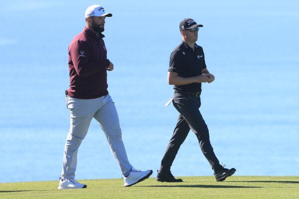 John Rahm and Justin Thomas walk up the fairway on the th hole of the South Course during the first round of the Farmers Insurance Open at Torrey Pines Golf Course in La Jolla, Calif., on Jan. 25, 2023. (Sean M. Haffey/Getty Images)