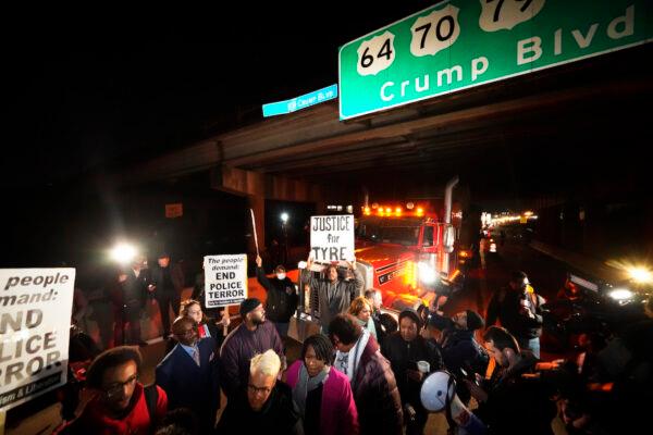 Protesters march down the street in Memphis, Tenn., on Jan. 27, 2023. (AP Photo/Gerald Herbert)