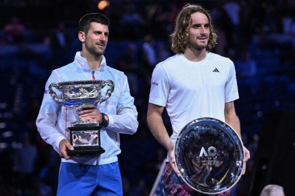 Serbia's Novak Djokovic (L) holding the Norman Brookes Challenge Cup poses with Greece's Stefanos Tsitsipas (R) afer his victory during the men's singles final on day fourteen of the Australian Open tennis tournament in Melbourne on Jan. 29, 2023.(William West/AFP via Getty Images)
