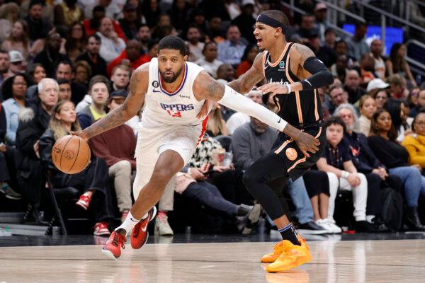 Paul George (13) of the LA Clippers dribbles around Dejounte Murray (5) of the Atlanta Hawks during the second half at State Farm Arena in Atlanta on Jan. 28, 2023. (Alex Slitz/Getty Images)