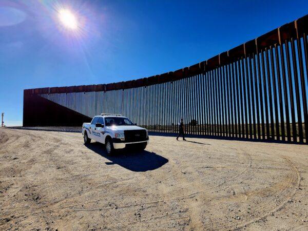 Police Lt. Marco Santana leaves his vehicle to inspect a section of the southern border wall at San Luis, Ariz., on Jan. 27, 2023. (Allan Stein/The Epoch Times)