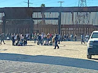 A large group of illegal migrants waits to be processed on the U.S. side of the border wall in San Luis, Ariz., about a month ago. (Courtesy of San Luis Police Lt. Marco Santana)