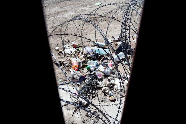 A pile of trash discarded by illegal migrants lies in the area between two sections of border wall in an area known as "no man's land" in San Luis, Ariz., on Jan. 27, 2023. (Allan Stein/The Epoch Times)