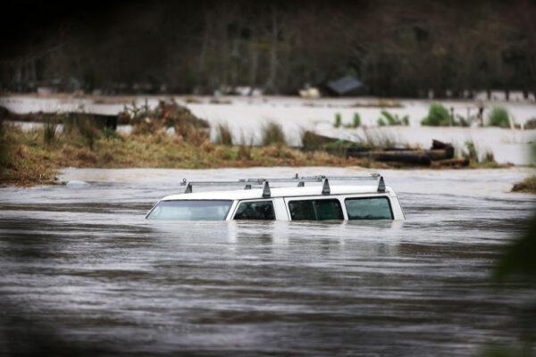 A vehicle is submerged in the Kumeu River as heavy rain causes extensive flooding and destruction in Auckland, New Zealand, on Aug. 31, 2021. (Fiona Goodall/Getty Images)