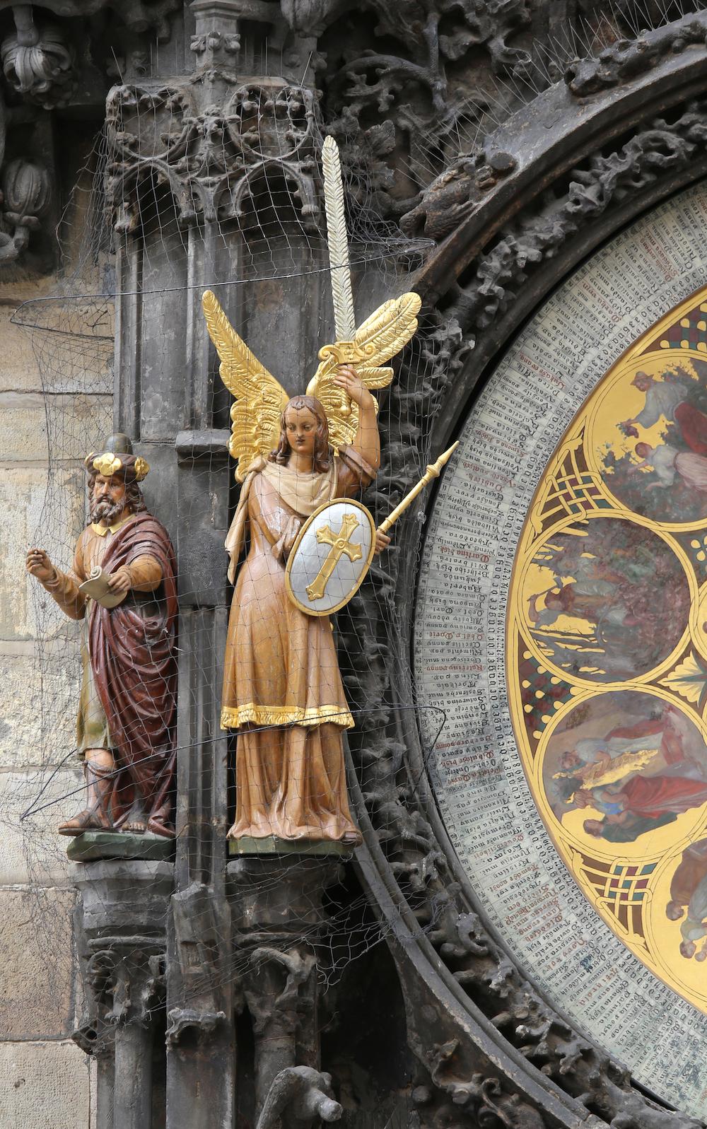 Philosopher and Archangel Michael statues beside the calendar face. (ChiccoDodiFC/Shutterstock)