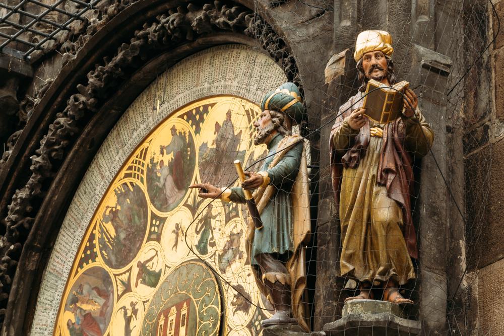Astronomer and chronicler statues beside the clock's calendar face. (Grisha Bruev/Shutterstock)